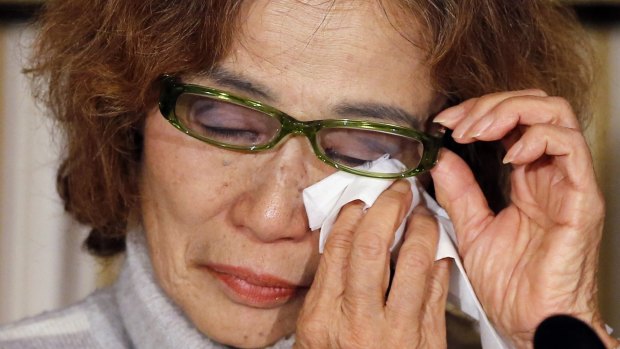 Junko Ishido, mother of Kenji Goto, a Japanese journalist being held captive by Islamic State militants, reacts during a news conference.