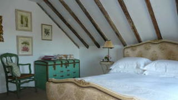 Simply French...exposed timber beams in the bedroom.