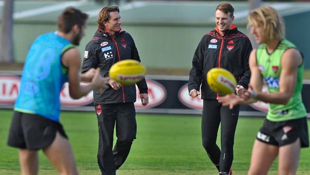 Labour of love: James Hird enjoys a light moment with Brendon Goddard (second from right) and Dyson Heppell (right,) on Friday.