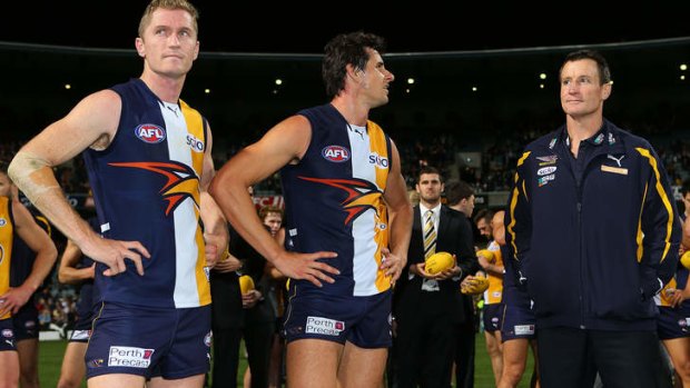 Adam Selwood, Andrew Embley and John Worsfold of the Eagles look on after the match against Adelaide Crows.