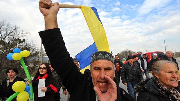 Dissent: A Tartar holds a Ukrainian flag at a demonstration in Bakhchisarai, south of Crimea's capital, Simferopol, against Russian influence.