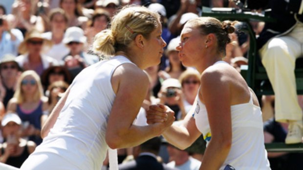 Kim Clijsters and Vera Zvonareva exchange a kiss after their quarter-final at Wimbledon.