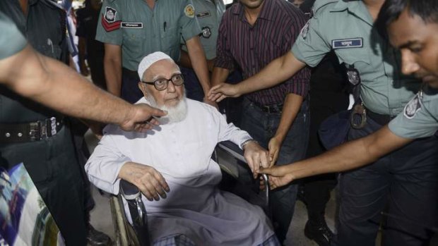 Ghulam Azam, former head of Jamaat-e-Islami party, exits a court after the verdict of his trial, in front of the International Crimes Tribunal-1 in Dhaka.