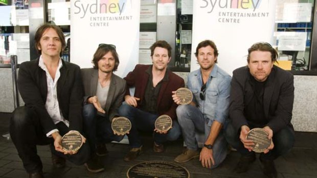 That's the ticket... Powderfinger with the plaque unveiled in their honour at the Sydney Entertainment Centre.