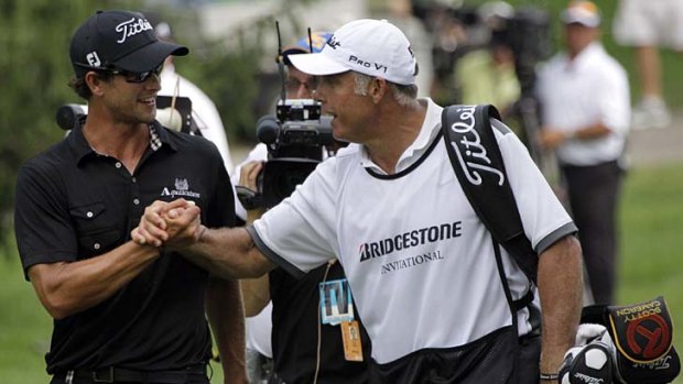 Adam Scott and his new caddie Steve Williams congratulate each other on the 18th.