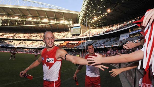 Tadhg Kennelly and Jared Moore thank fans after their win over North Melbourne at Etihad Stadium, April 2010.