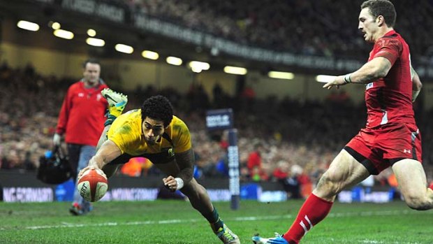 Joe Tomane scores for the Wallabies after scooping up a flat pass by Israel Folau.