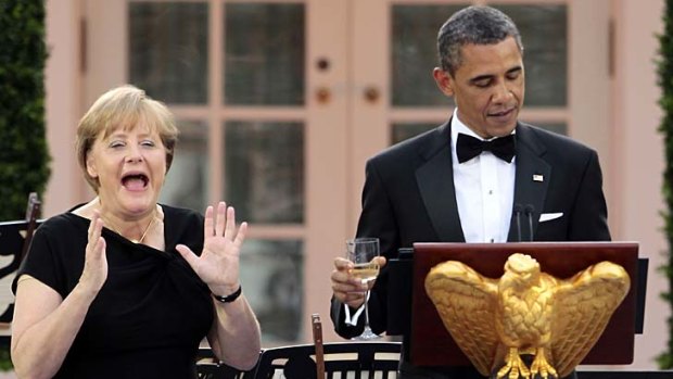 President Barack Obama toasts German Chancellor Angela Merkel at a state dinner held in her honour in the Rose Garden at the White House.