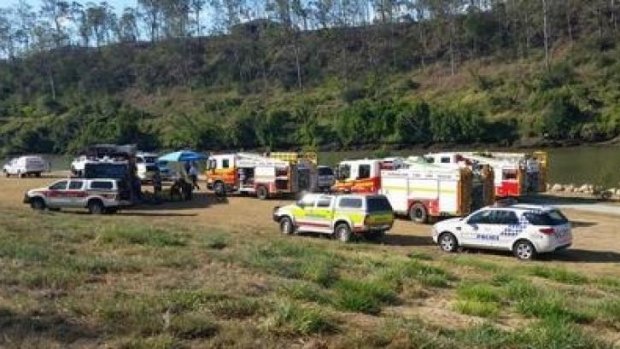 Emergency crews search for a man missing in the Brisbane River at Karana Downs.