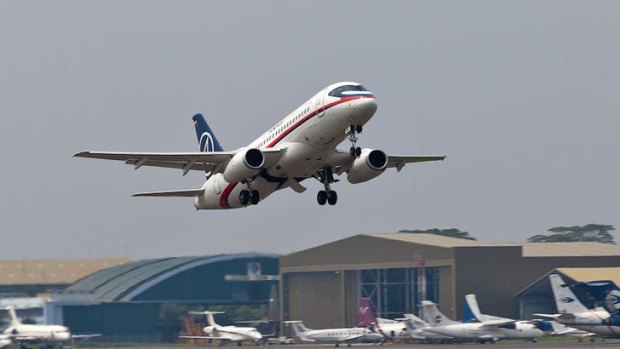 In this photo released by Sergey Dolya, a Sukhoi Superjet-100 takes off from Halim Perdanakusuma airport in Jakarta.