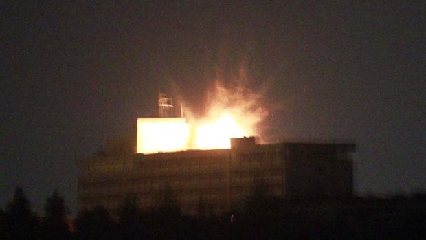 The roof of the Inter-Continental hotel is lit up by an explosion during a battle between NATO-led forces and Taliban insurgents.