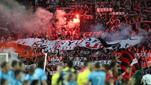 Western Sydney Wanderers fans let off flares in the stands during the Sydney derby in December.