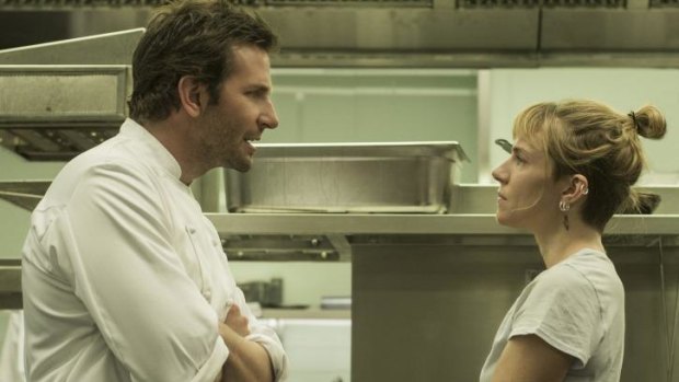 Bradley Cooper and Sienna Miller face-off in the kitchen in <i>Burnt.</i>