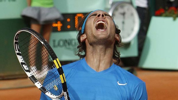 Lucky escape ... Rafael Nadal celebrates after defeating John Isner.