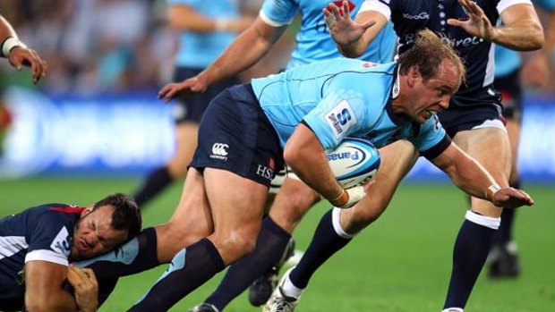 Going nowhere ... Waratahs skipper Phil Waugh is brought down by a Rebels defender.