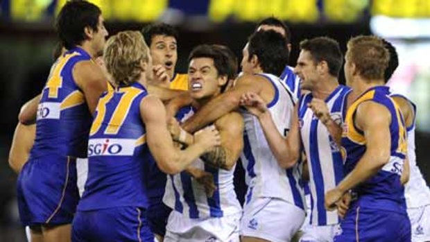 In the thick of it ... tempers spilled over during yesterday’s game between North Melbourne and West Coast Eagles...The Kangaroos were a different team from the one that was thumped by St Kilda last weekend.