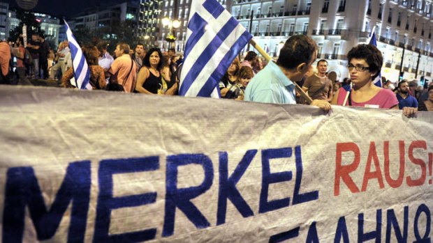 Hostility ... Protesters hold a banner reading "Merkel out!" at an anti-austerity demonstration in Athens before the German chancellor's visit.