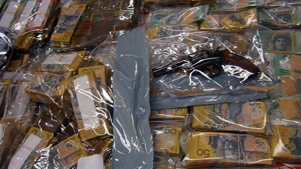 Cash and a gun that was among the record haul seized by police.