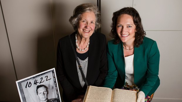 Sir Alexander Downer's daughter, Stella Downer, and granddaughter Georgina Downer with the manuscript he produced during his captivity in Signapore's Changi prison camp. 
