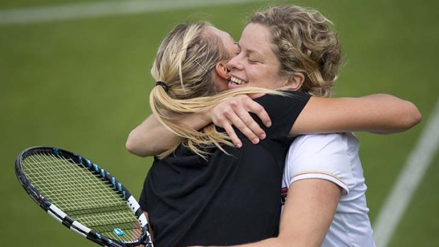 Russia's Maria Sharapova (left) embraces Belgium's Kim Clijsters during a practice session on the eve of the Wimbledon Championships.