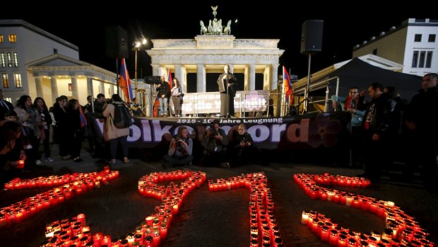 The year 1915 is formed with candles during a memorial march by Armenians in front of the Brandenburg Gate after an Ecumenical service marking the 100th anniversary of the mass killings of 1.5 million Armenians by Ottoman Turkish forces, at the cathedral in Berlin.