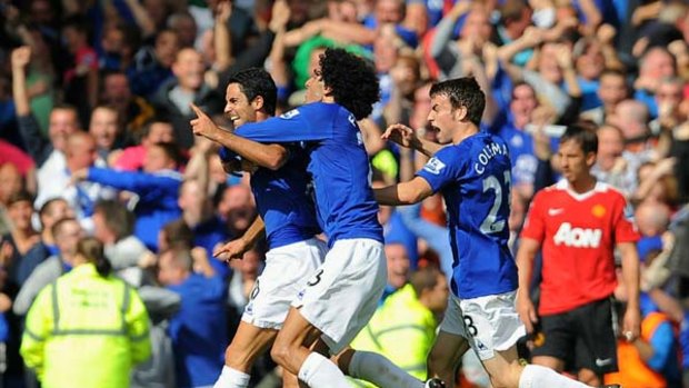 Mikel Arteta of Everton celebrates with teammates after scoring to make it 3-3 in the Barclays Premier League match between Everton and Manchester United.