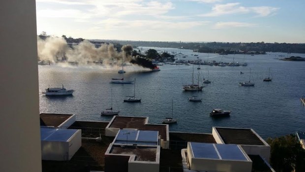 A boat is on fire near Birkenhead Point at Iron Cove Bay.