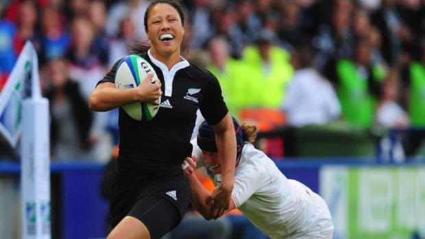 Carla Hohepa of New Zealand is tackled by Joanna McGilchrist of England.