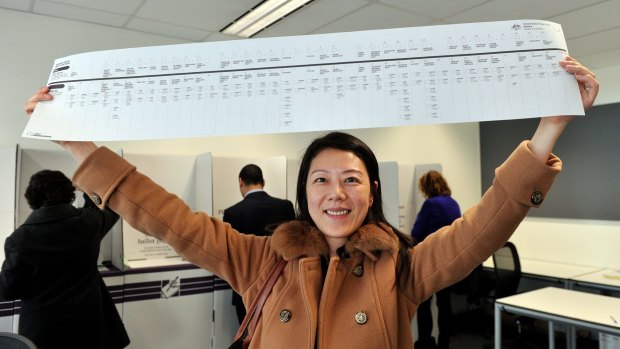 Can you count from 1 to 97? Voter Sumin Sun holds up a metre-long Senate ballot from the 2013 election.