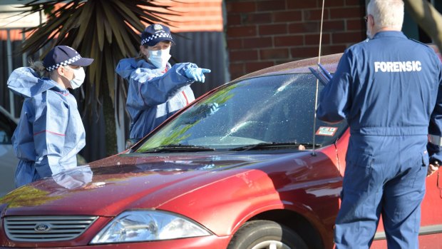Police examine a car at the Thomastown house.