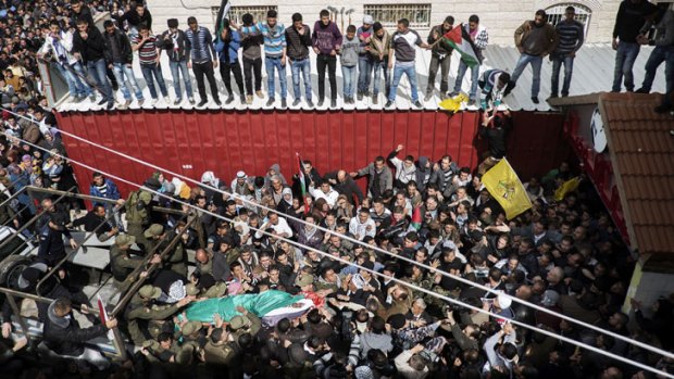 Palestinian mourners carry the body of Arafat Jaradat, an inmate who died in an Israeli prison, during his funeral in the West Bank village of Saaer.