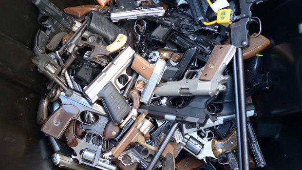 A bin full of handguns. By noon, police had collected more than 420 weapons.