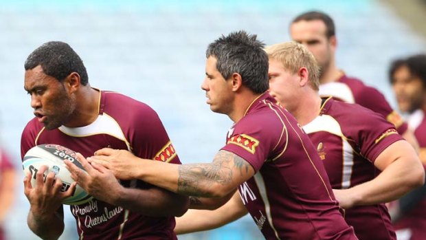 Plenty of Petero in his tank ... Queensland's Petero Civoniceva takes the ball up at Maroons training yesterday with teammate Corey Parker in tow.