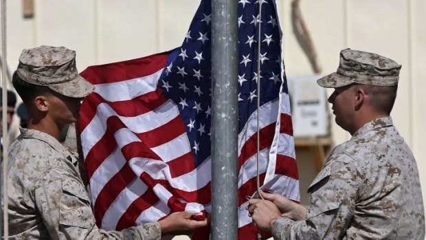 Going home: US Marines lower their flag for the last time.