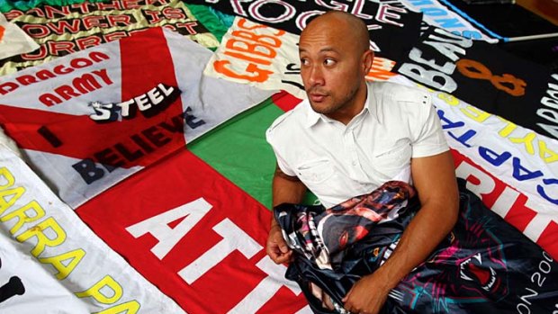 No.1 fan ... Penrith prop Frank Puletua surrounds himself in banners and flags he has gathered for an exhibition to celebrate the passion of league fans.