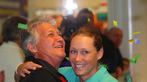 Sam Stosur is greeted by her father, Tony, at Brisbane Airport yesterday.