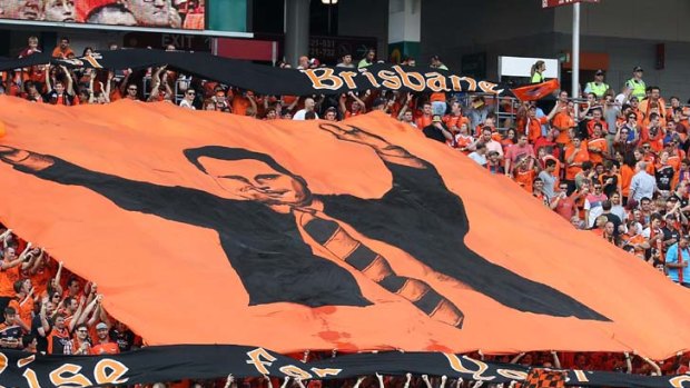 Roar fans show their support for coach Ange Postecoglou at the A-League Grand Final match.  (Photo by Bradley Kanaris/)