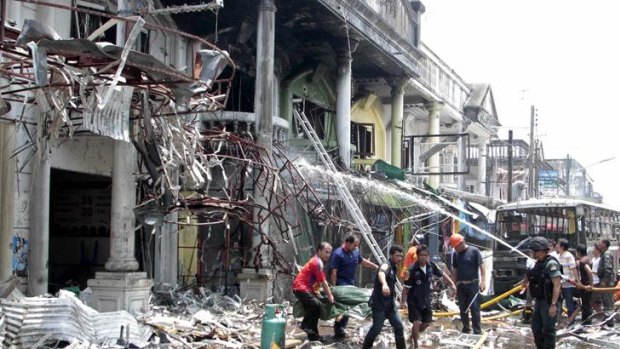 Rescue workers remove a body after a bomb blast in southern Thailand's Yala province on Saturday.