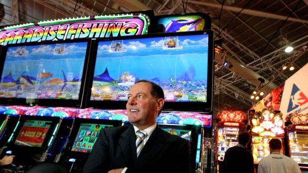 Getting hooked ... Ross Ferrar, chief executive of the Gaming Technologies Association, with the new Paradise Fishing machine.