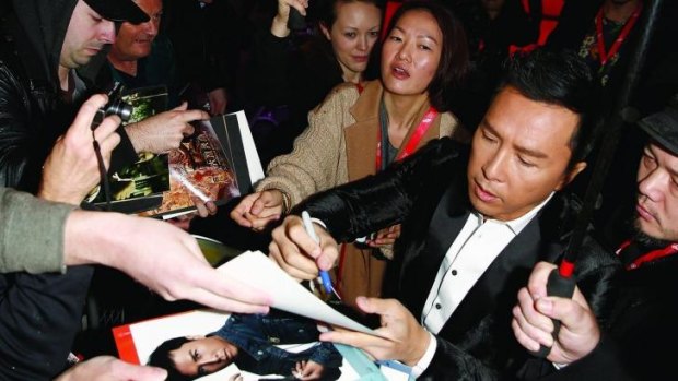 In demand: Donnie Yen autographs posters at the London Film Festival.