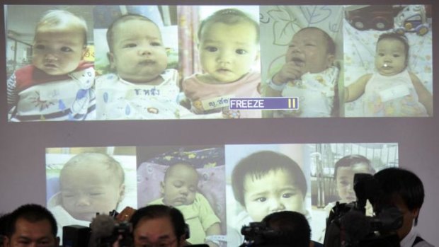 Surrogate babies that Thai police suspect were fathered by a Japanese businessman who has fled from Thailand are shown on a screen during a news conference in Bangkok.