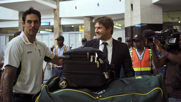 Australian cricket players Shane Watson (C) and Mitchell Johnson (L) arrive at Johannesburg airport.