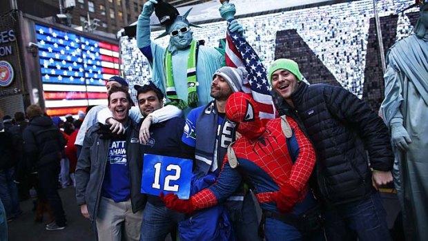 Seattle Seahawks fans pose for a picture in Times Square while they visit the Super Bowl Boulevard fan zone.
