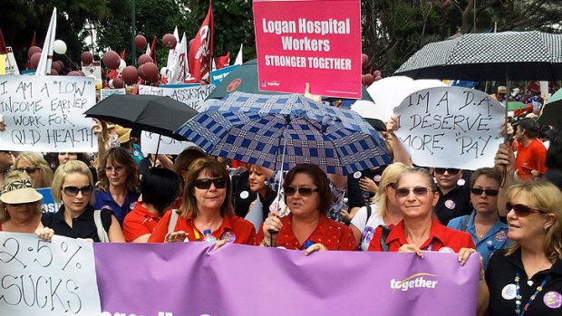 Hospital workers rally for better pay outside Parliament House.