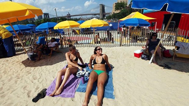 Locals relax at the Brooklyn Bridge Park pop-up pool in New York. People say the Big Apple should be avoided in summer, but there are good reasons to go.