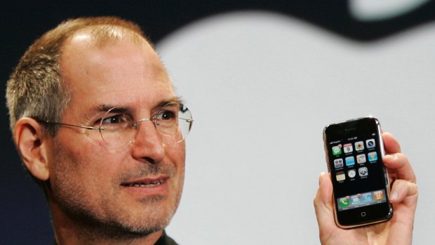 Apple CEO Steve Jobs with the first iPhone, which has just turned 10 years old.