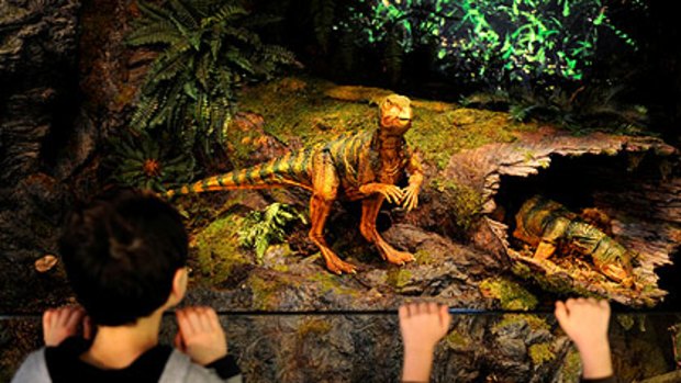 Animatronic dinosaurs react with a couple of visitors to the latest Melbourne Museum exhibition, <i>600 Million Years: Victoria Evolves</i>, which opened yesterday.
