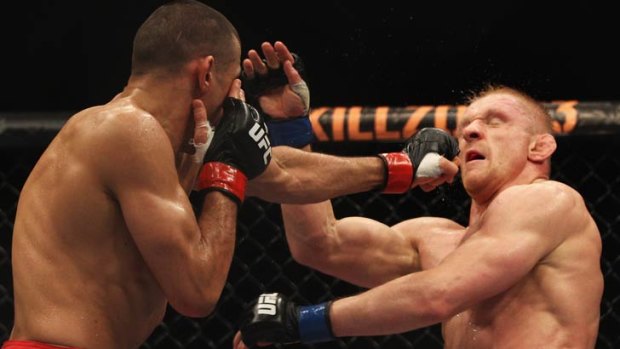 George Sotiropoulos (left) lands a punch during a 2011 loss to Germany's Dennis Siver.