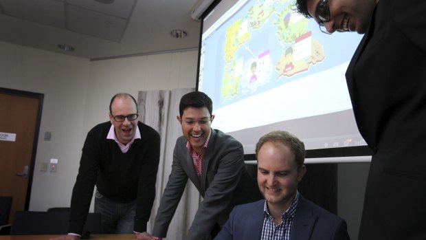 Art of the deal: Dr Robert Jack (far left) and Dr Mauricio Marrone with students playing the Traders of Macquarie University game.
