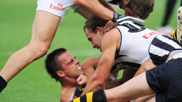 Richmond's Jake King clashes with Collingwood opponents last Friday.